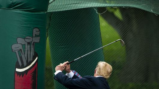 U.S. President Donald Trump swings a golf club during the White House Sports and Fitness Day event in Washington, D.C., U.S., on May 30, 2018. 