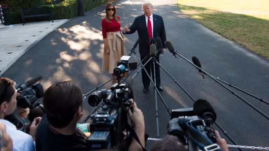 US President Donald Trump speaks to the media alongside First Lady Melania Trump as they walk to Marine One prior to departure from the South Lawn of the White House in Washington, DC, July 10, 2018, as they travel on a week-long trip to Europe, with stops in Brussels, London, Scotland and Helsinki. (Photo by SAUL LOEB / AFP)        (Photo credit should read SAUL LOEB/AFP/Getty Images)