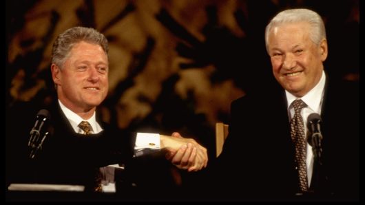 US Pres. Bill Clinton (L) & Russian Pres. Boris Yeltsin warmly shaking hands, all-smiles during summit press conference in March of 1997 in Finland.