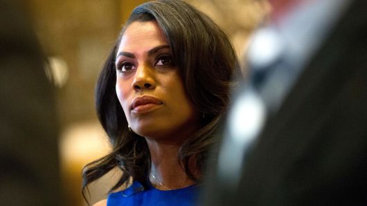 Omarosa Manigault, a staffer for US President-elect Donald Trump, listens as Martin Luther King III speaks to the media after meeting with the President-elect at Trump Tower in New York City on January 16, 2017.