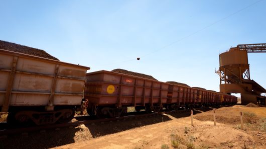 A train loader fills train carriages with lump iron ore at Rio Tinto Group's West Angelas iron ore mine in Pilbara. The miner's plans to replace trains with driverless ones hit a delay in Q1.