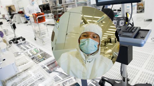 A technician inspects a 300mm silicon wafer at the Applied Materials Maydan Technology Center in Santa Clara, California.