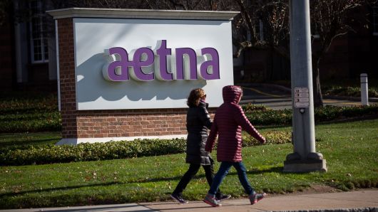 Pedestrians walk past Aetna headquarters in Hartford, Connecticut.