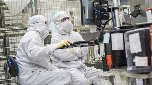 Technicians work on machinery at the Applied Materials facility in Santa Clara, California.