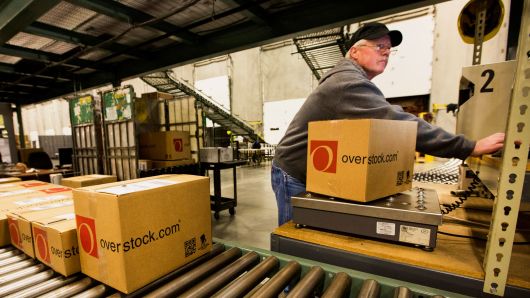 An employee scans an order in the shipping area at the Overstock.com distribution center in Salt Lake City, Utah.