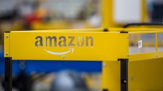 An Amazon logo sits on a collection cart for customer orders at the Amazon.Com fulfillment center in Dobroviz, Czech Republic, on Sept. 8, 2015.