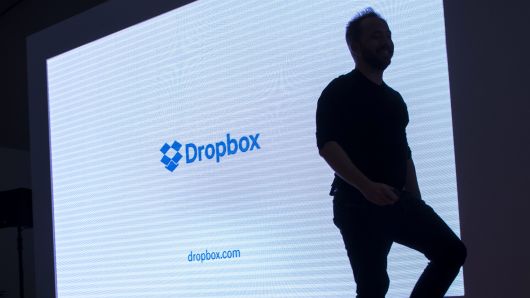 The silhouette of Drew Houston, chief executive officer and co-founder of Dropbox Inc., is seen walking on stage during an event in San Francisco.
