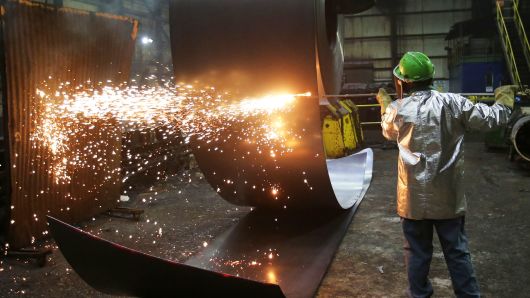A worker cuts a steel coil at the Novolipetsk Steel PAO steel mill in Farrell, Pennsylvania, March 9, 2018.