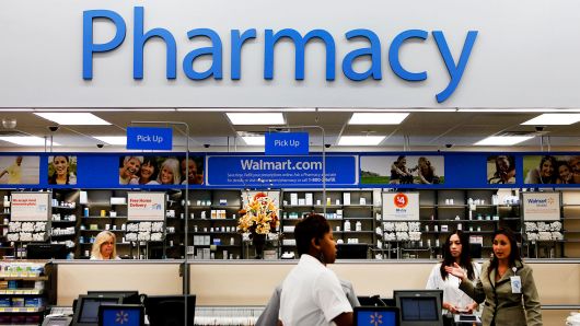 A customer walks past the pharmacy at a Walmart in Torrance, California.
