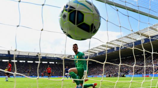A dejected David De Gea of Manchester United looks at the ball in his net as Leonardo Ulloa of Leicester City scores his team's opening goal during the Barclays Premier League match between Leicester City and Manchester United at The King Power Stadium on September 21, 2014