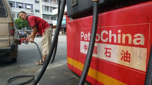 A driver fills his car at a PetroChina gas station in Guangzhou, China.
