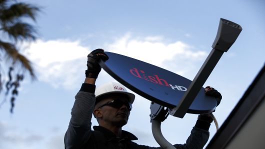 A Dish Network Corp. field service specialist installs a satellite television system at a residence in Downey, California.