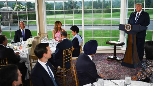 President Donald Trump (R) speaks, flanked by First Lady Melania Trump (2nd L), Boeing CEO Dennis Muilenburg (L) and CEO of PepsiCo Indra Nooyi (3rd L), during a dinner with business leaders in Bedminster, New Jersey, on August 7, 2018.