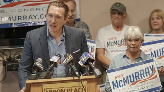 In this photo provided by Nate McMurray for Congress, Democratic congressional candidate Nate McMurray speaks to supporters in Rochester, N.Y., Thursday, Aug. 9, 2018, the day after his opponent, U.S. Rep. Christopher Collins, R-N.Y., was arrested on insider trading charges. 