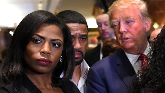 Omarosa Manigault (L)  who was a contestant on the first season of Donald Trump's 'The Apprentice' and is now an ordained minister, appears alongside Republican presidential hopeful Donald Trump during a press conference November 30, 2015  that followed Trump's meeting with African-American religious leaders in New York. 