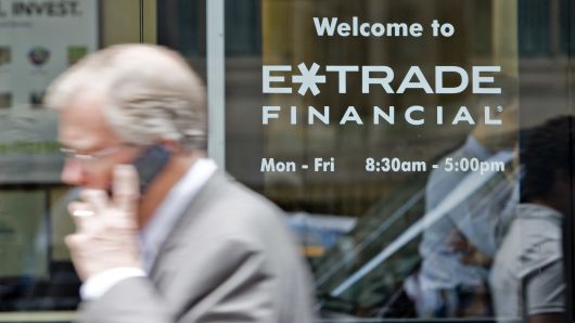 Pedestrians walk outside an E*Trade Financial office in New York, U.S.