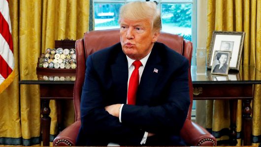 President Donald Trump reacts to a question during an interview in the Oval Office of the White House in Washington, August 20, 2018. 