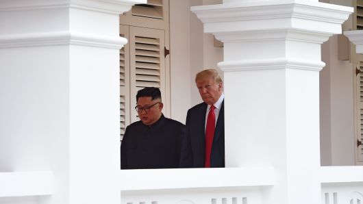 North Korea's leader Kim Jong Un (L) walks out with US President Donald Trump (R) to face the media after taking part in a signing ceremony at the end of their historic US-North Korea summit, at the Capella Hotel on Sentosa island in Singapore on June 12, 2018.