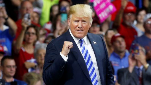 President Donald Trump pumps his fist at supporters after speaking at a Make America Great Again rally at the Civic Center in Charleston, West Virginia, August 21, 2018. 