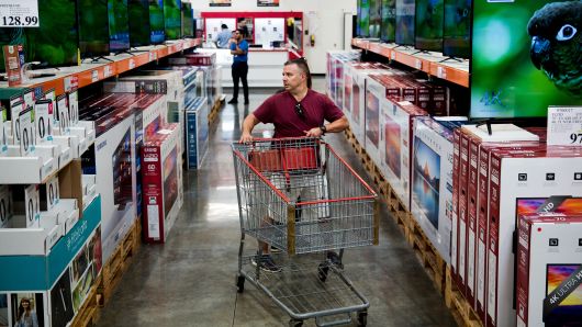 A customer browses televisions inside a Costco Wholesale store in Miami, Florida. 