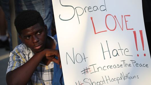 A sign that reads, 'Spread Love Not Hate!!,' calling for an end to gun violence as the gaming community deals with the aftermath of a shooting during a Madden 19 video game tournament which killed 3 people including the gunman on Aug. 27, 2018.