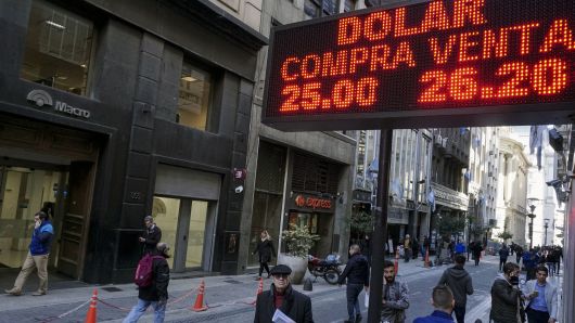 Currency exchange values are seen in the buy-sell board of a bureau de change in the financial district of Buenos Aires.