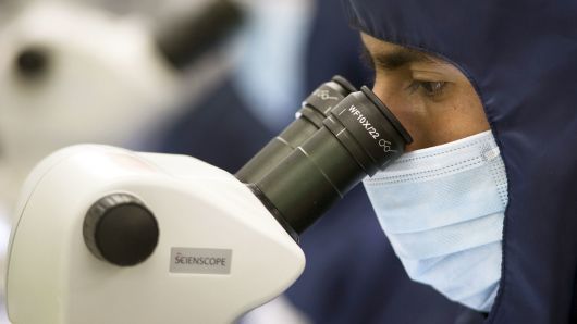 An employee uses a microscope at the Medtronic assembly plant in Tijuana, Mexico.