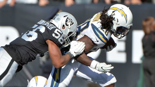 Melvin Gordon #28 of the Los Angeles Chargers scores a six-yard touchdown against the Oakland Raiders during their NFL game at Oakland-Alameda County Coliseum on October 15, 2017 in Oakland, California.