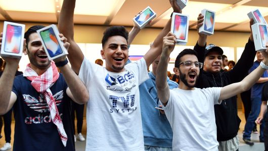 First customers display their iPhone X devices at an Apple showroom in Sydney, Australia on November 3, 2017.