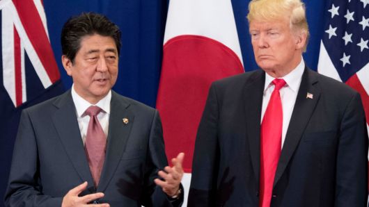 Japan's Prime Minister Shinzo Abe talks to US President Donald Trump during the opening ceremony of the 31st Association of Southeast Asian Nations (ASEAN) Summit in Manila on November 13, 2017.