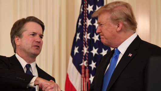 US Judge Brett Kavanaugh (L) shakes hands with US President Donald Trump after being nominated to the Supreme Court in the East Room of the White House on July 9, 2018 in Washington, DC. 