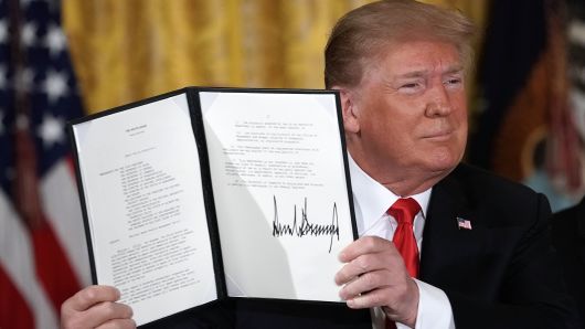 President Donald Trump holds up an executive order that he signed during a meeting of the National Space Council at the East Room of the White House June 18, 2018 in Washington, DC. President Trump signed an executive order to establish the Space Force, an independent and co-equal military branch, as the sixth branch of the U.S. armed forces. 
