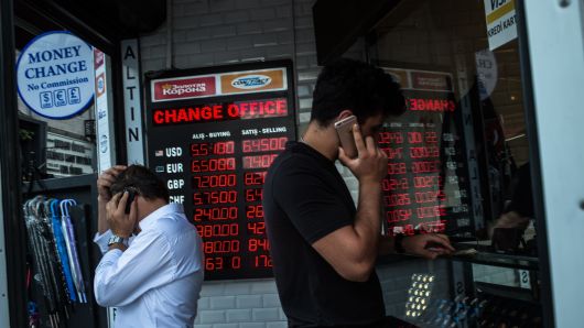 People check currency exchange rates at a currency exchange office on August 11, 2018 in Istanbul. 