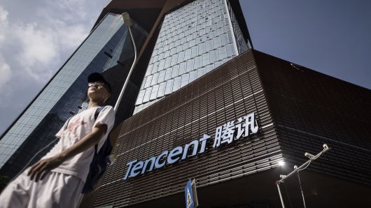 A pedestrian walks past Tencent Holdings Ltd.'s new under construction headquarters in Shenzhen, China;