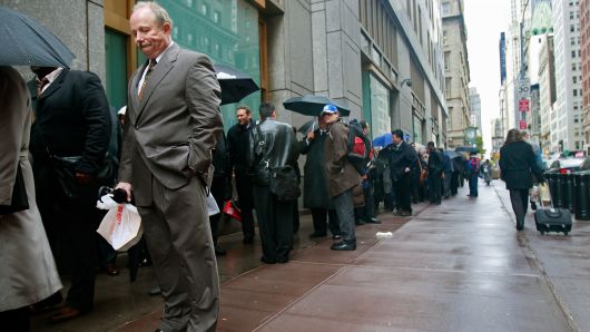 A man waits on line with other job seekers at the Internal Revenue Service (IRS) Career Open House October 28, 2008 in New York City. 