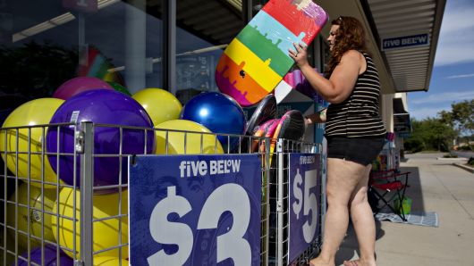 A shopper browses a selection of body boards outside a Five Below store in Bloomington, Illinois, on Wednesday, July 25, 2018. 