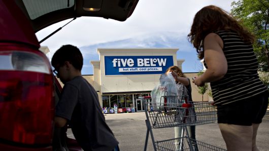 Shoppers place purchases into vehicle outside a Five Below store in Bloomington, Illinois, on Wednesday, July 25, 2018. 
