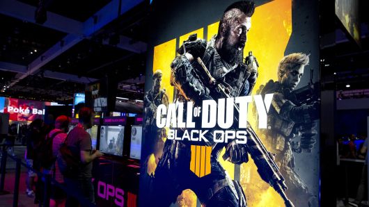 Attendees play the Activision Blizzard Inc. Call Of Duty: Black Ops 4 video game at the company's booth during the E3 Electronic Entertainment Expo in Los Angeles, California, U.S., on Tuesday, June 12, 2018. 