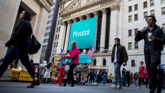 Pedestrians pass Pivotal Software Inc. signage displayed outside the New York Stock Exchange (NYSE) during the company's initial public offering (IPO) in New York, U.S., on Friday, April 20, 2018. 