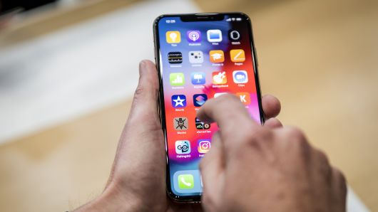 An attendee demonstrates the Apple  iPhone XR smartphone during an event at the Steve Jobs Theater in Cupertino, California, on Wednesday, Sept. 12, 2018. 