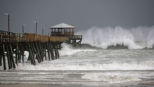 Waves crash around the Oceana Pier as the outer edges of Hurricane Florence being to affect the coast September 13, 2018 in Atlantic Beach, United States. Coastal cities in North Carolina, South Carolina and Virgnian are under evacuation orders as the Category 2 hurricane approaches the United States. 