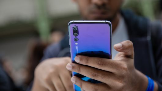 An attendee inspects a P20 Pro smartphone, manufactured by Huawei Technologies Co., during its unveiling in Paris, France, on Tuesday, March 21, 2018. 