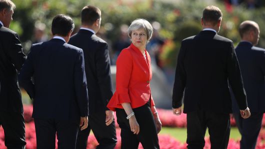 British Prime Minister Theresa May looks back as she and other leaders depart following the family photo on the second day of an informal summit of leaders of the European Union on September 20, 2018 in Salzburg, Austria. 