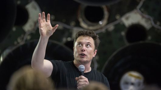 Elon Musk speaks near a Falcon 9 rocket during his announcement that Japanese billionaire Yusaku Maezawa will be the first private passenger who will fly around the Moon aboard the SpaceX BFR launch vehicle.