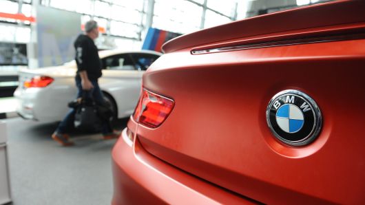 A visitor of BMW World walks past a BMW car during the annual accounts press conference of German car manufacturer BMW at the BWM World in Munich, Germany.