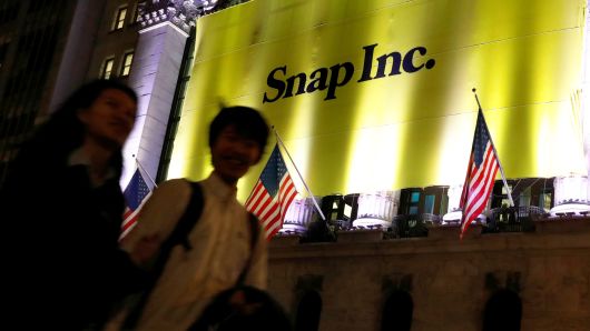 A banner for Snap Inc. hangs on the facade of the the New York Stock Exchange on the eve of the company's IPO in New York.