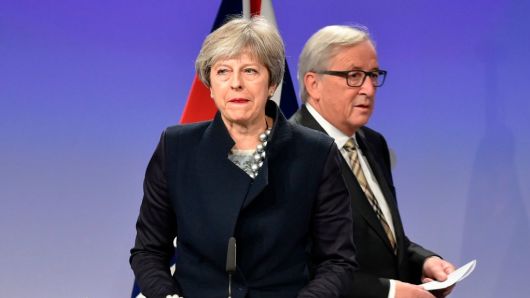 British Prime Minister Theresa May (L) and European Commission chief Jean-Claude Juncker give a press conference as they meet for Brexit negotiations on December 4, 2017 at the European Commission in Brussels.