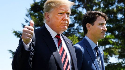 President Donald Trump (L) gives a thumbs up to the media as he is greeted by Prime Minister of Canada Justin Trudeau during the G7 official welcome at Le Manoir Richelieu on day one of the G7 meeting on June 8, 2018 in Quebec City, Canada.