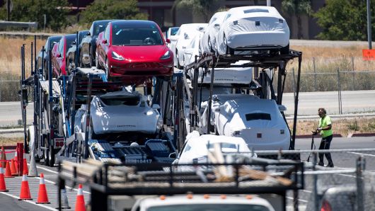 Tesla vehicles are loaded onto a truck for transport at the company's manufacturing facility in Fremont, California, on Wednesday, June 20, 2018. 