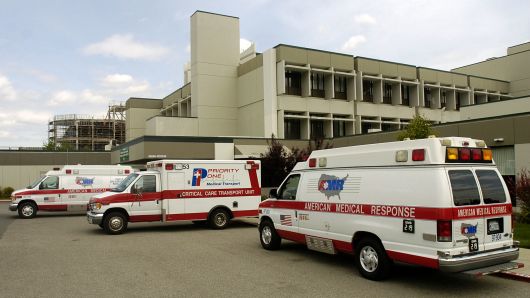 Ambulances are parked outside the emergency room at Good Samaritan Hospital in San Jose, California. 